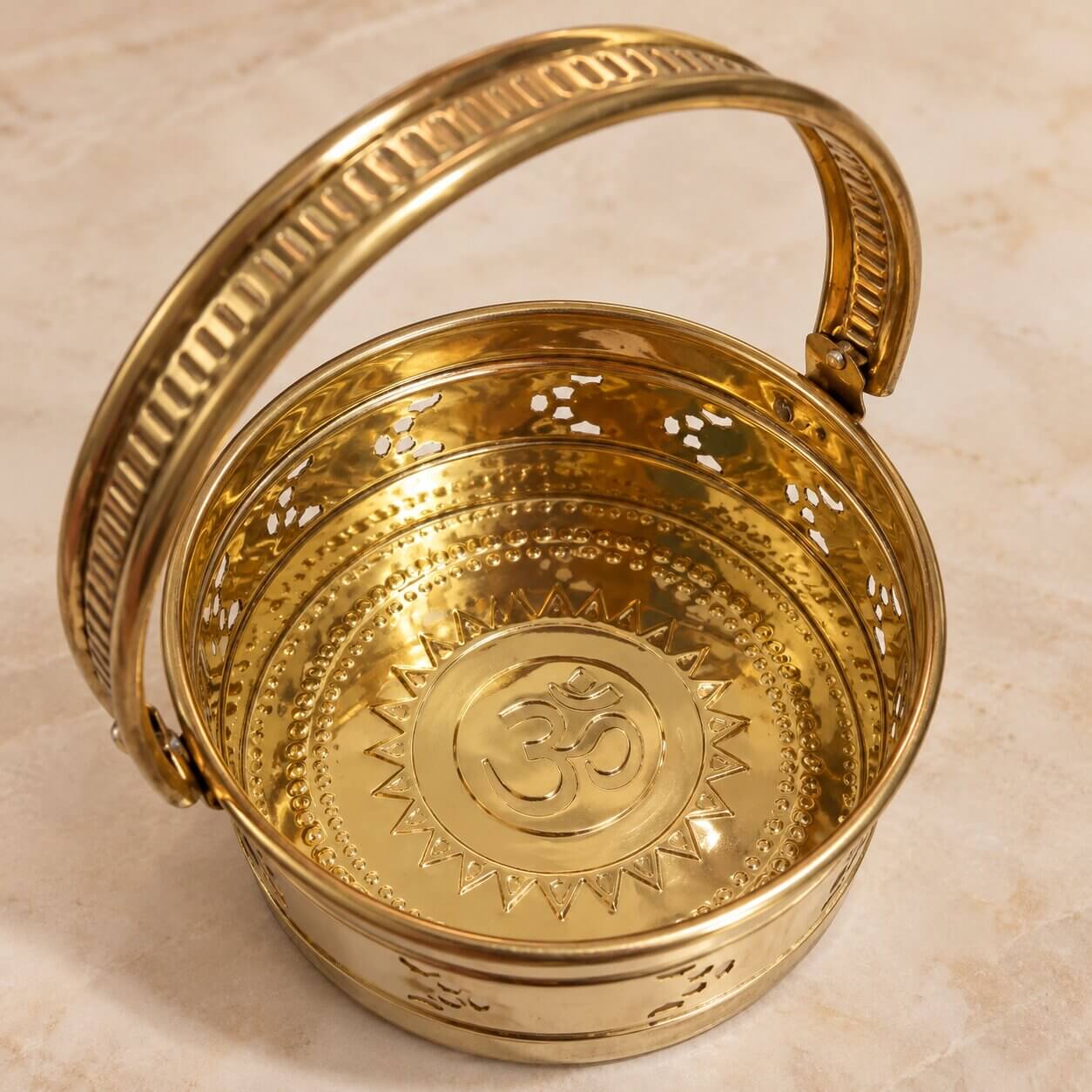 Sacred Om at the base of brass flower basket