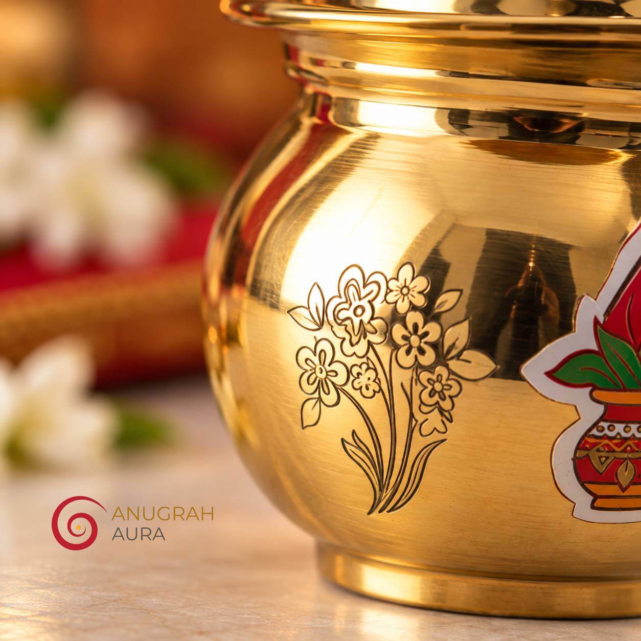 Close-up of floral engraving and decorative kalash motif on a brass ghee pot
